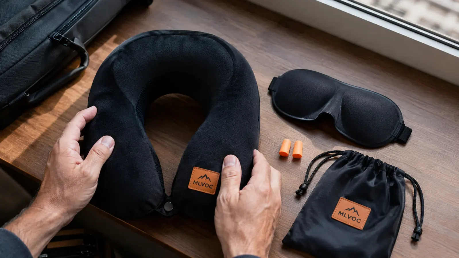 MLVOC travel pillow kit laid flat showing the 3D eye mask, earplugs, and carry bag alongside the neck pillow